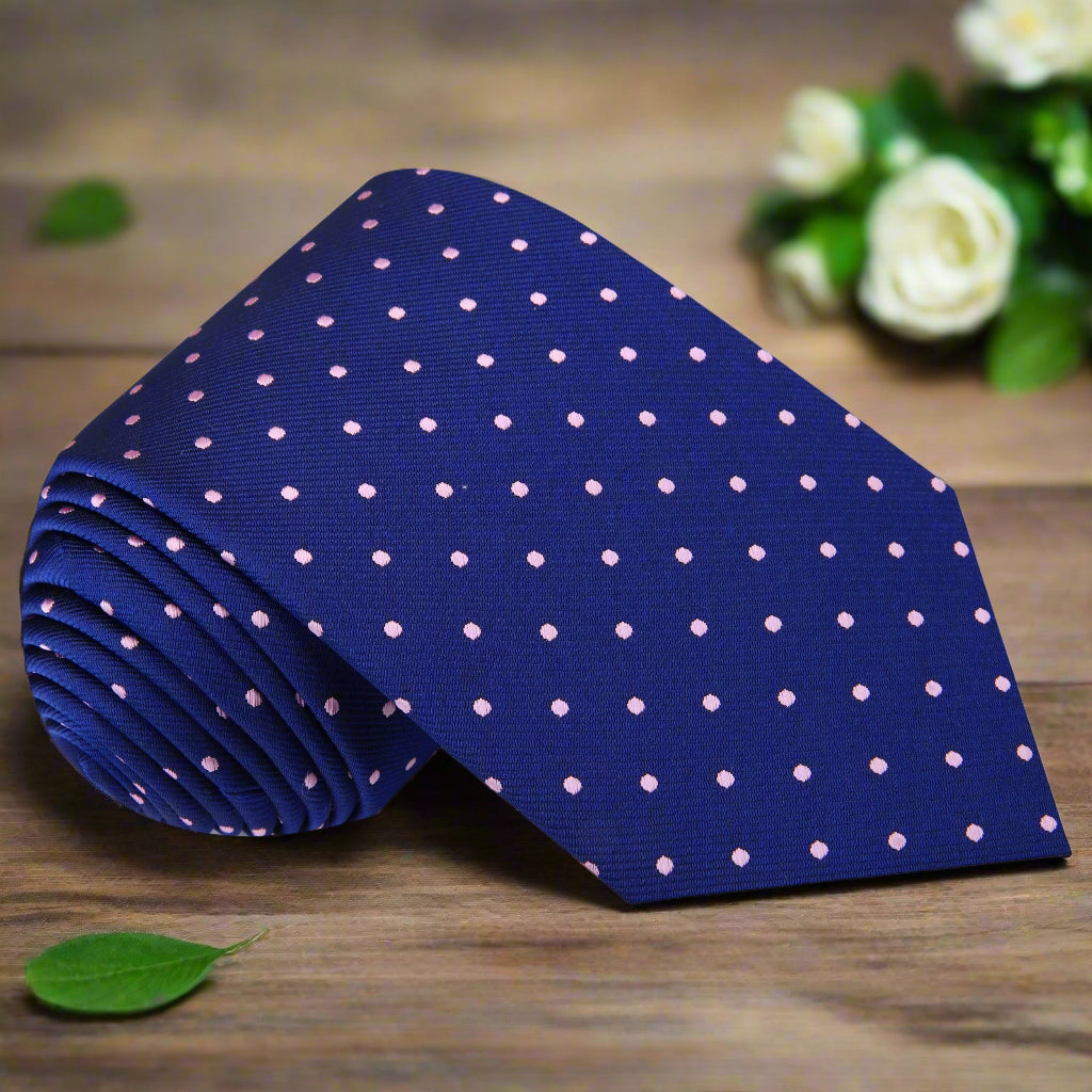 Elegant dark blue polka dot necktie paired with a crisp white dress shirt, perfect for business meetings.