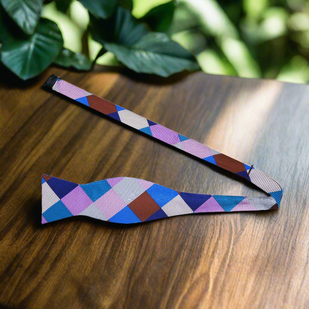Close-up of the geometric silk bow tie showcasing vibrant diamond pattern