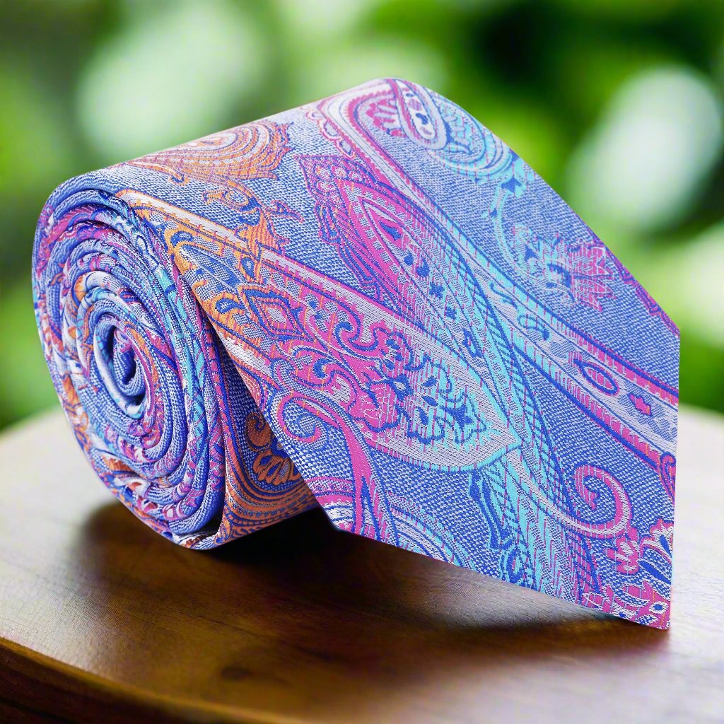 Vibrant paisley silk necktie displayed on a white dress shirt.