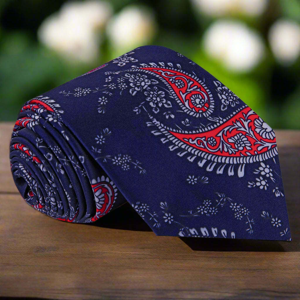 Dark blue and red paisley necktie displayed elegantly on a white background
