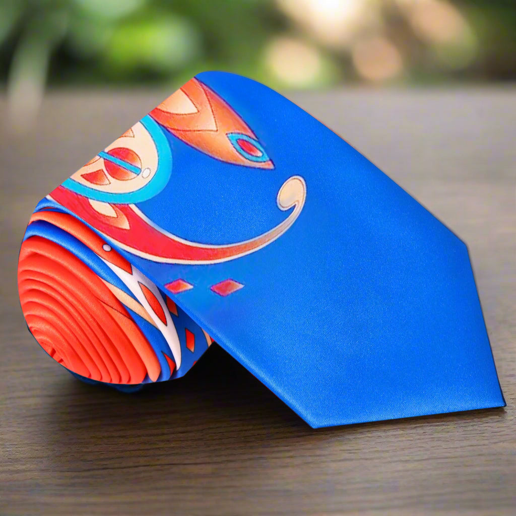 Close-up of vibrant paisley silk tie with bold orange and blue colors