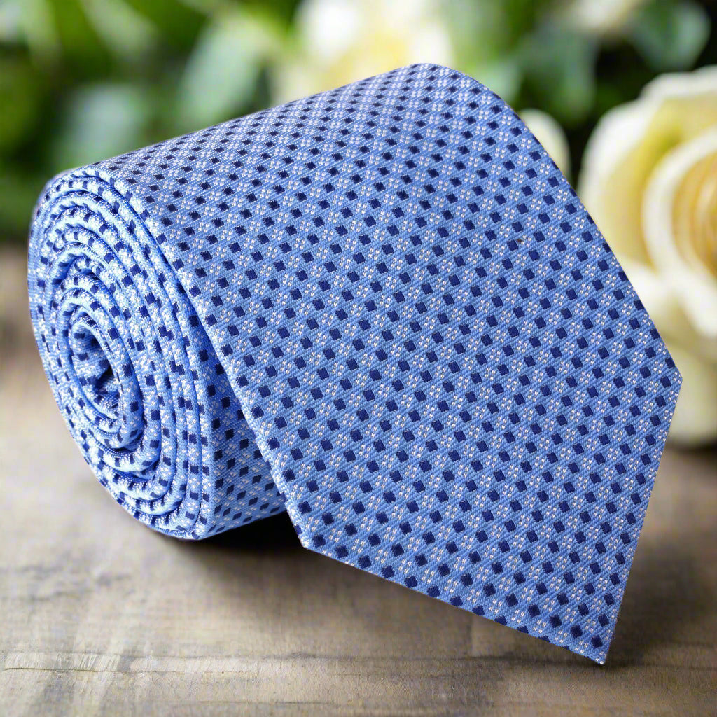 Front view of the elegant light blue silk tie with a geometric pattern, showcasing its intricate design.