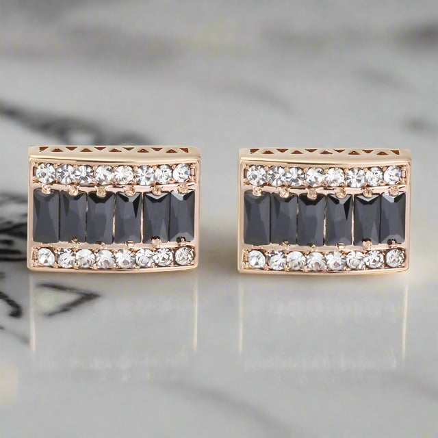Luxury gold and black rectangular cufflinks on a dress shirt, perfect for formal occasions