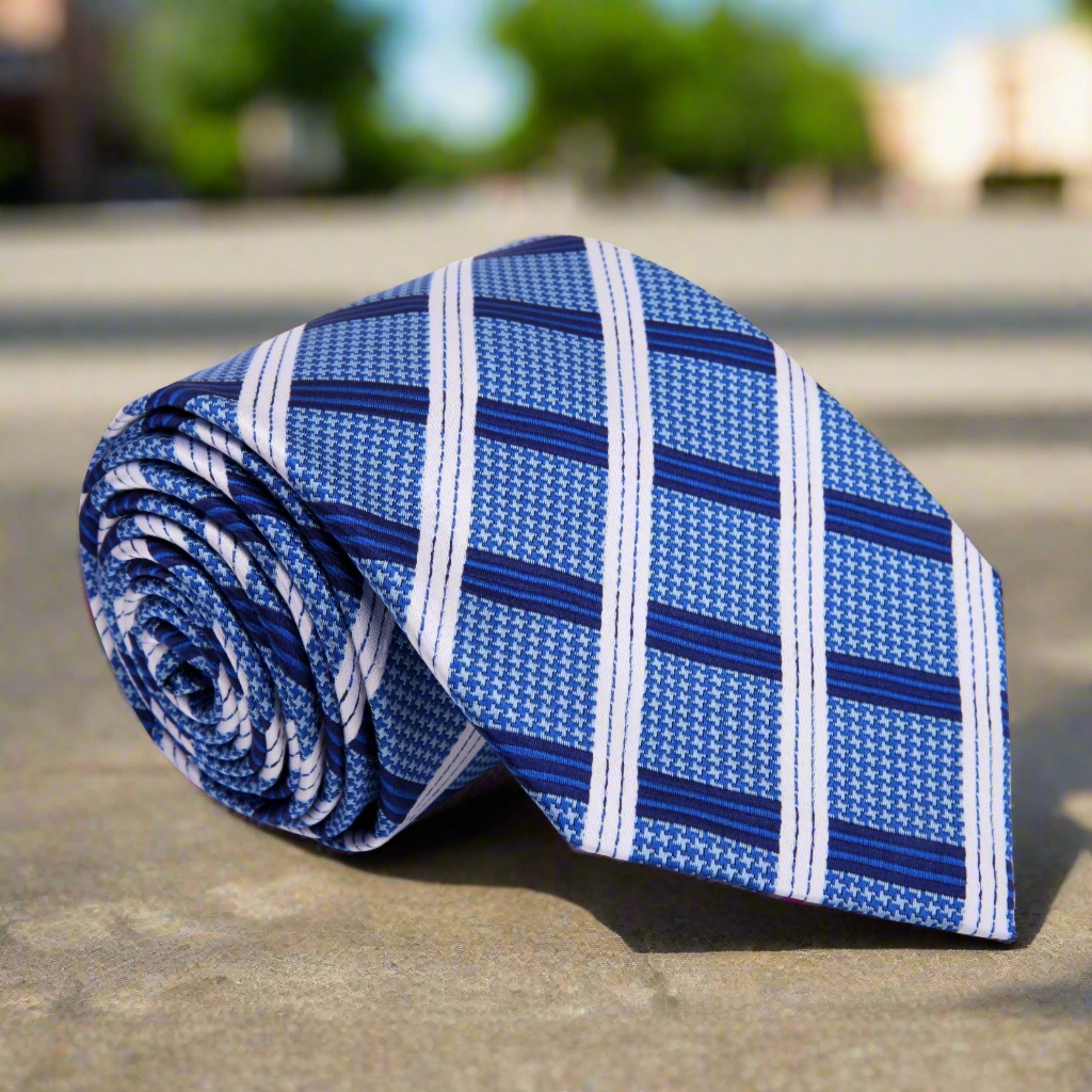 Front view of a plaid silk necktie in blue and white for business meetings