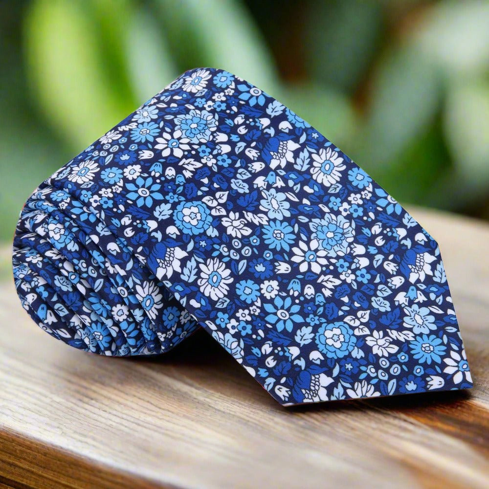 Close-up of the elegant green floral silk tie showcasing intricate floral patterns.