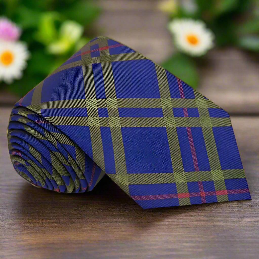 Cobalt plaid silk tie displayed on a white dress shirt, showcasing its vibrant colors.