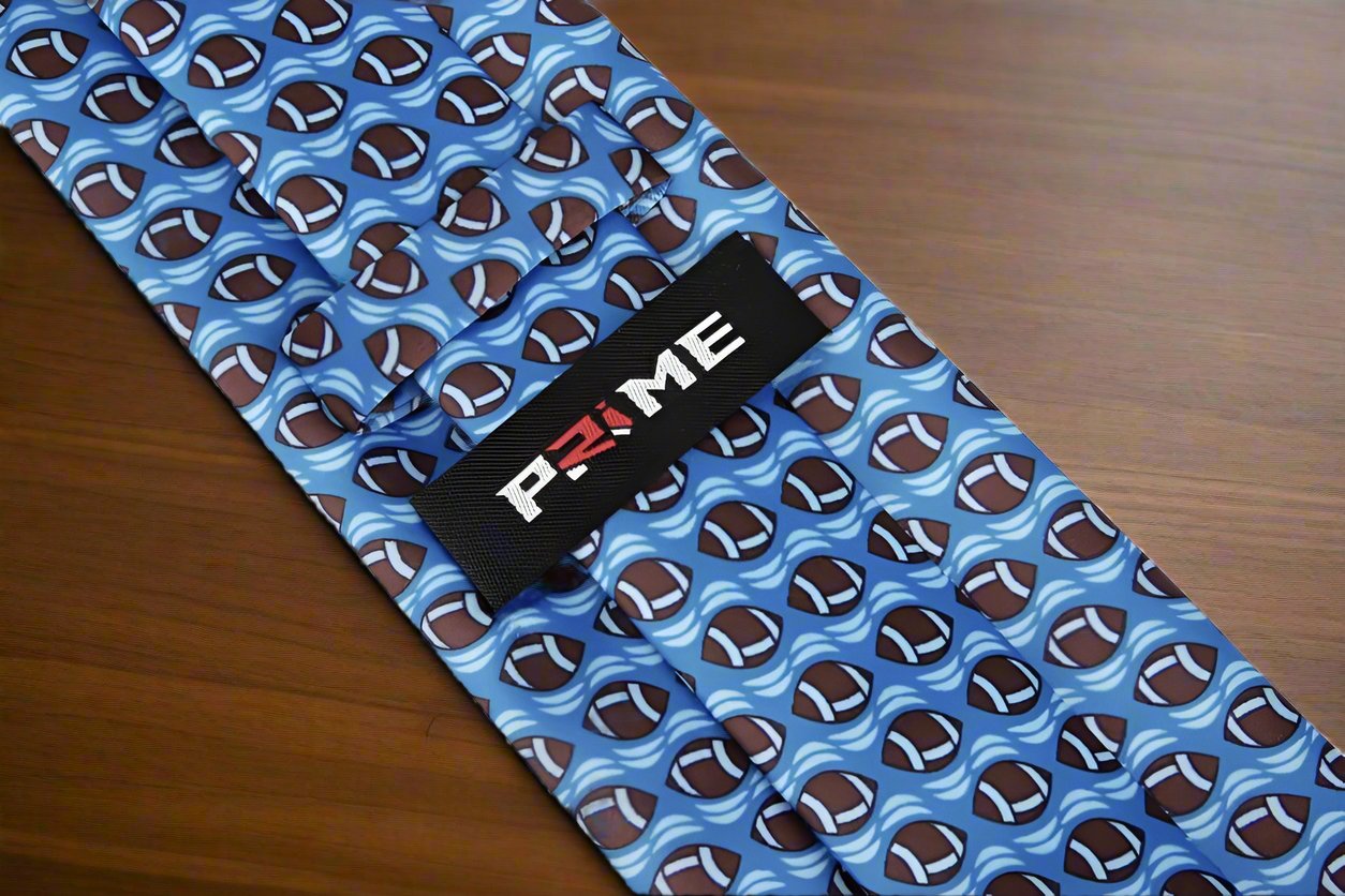 Close-up of the football pattern on a stylish blue necktie.