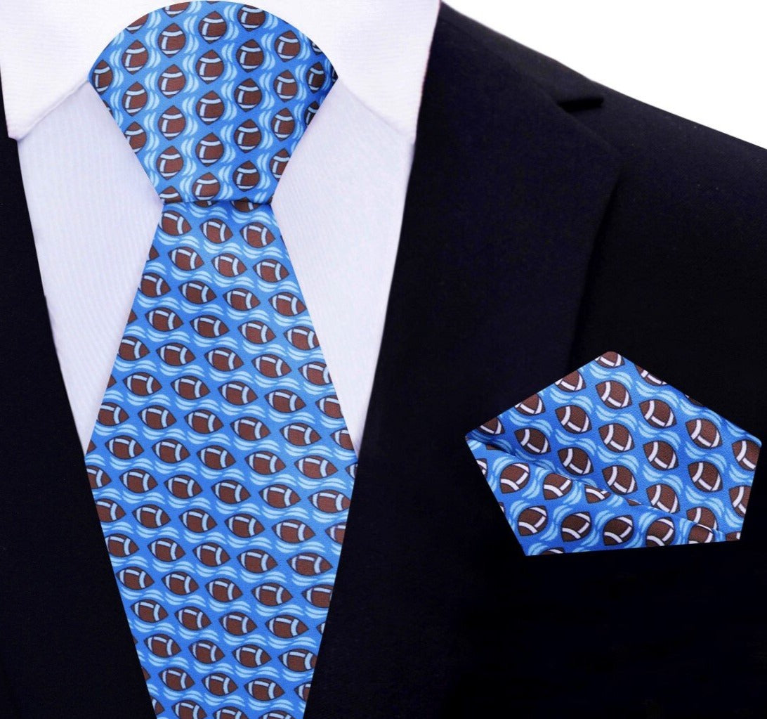 Man wearing a blue football tie paired with a light blue dress shirt at a casual event
