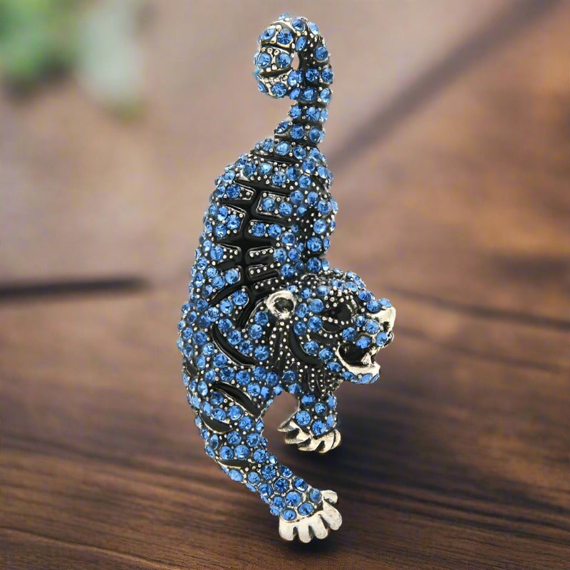 Close-up of a gemstone lion lapel pin with detailed craftsmanship