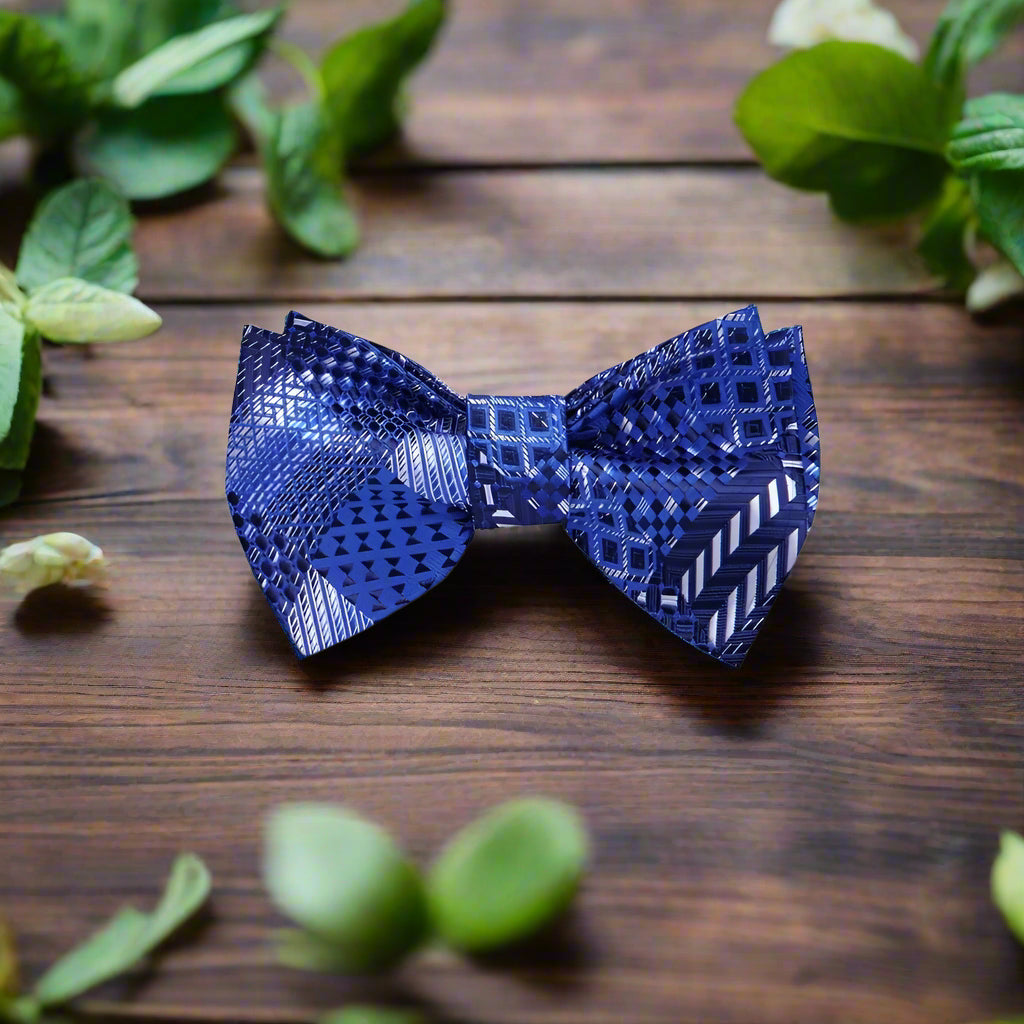 Close-up of chic grey plaid self-tie bow tie against a white dress shirt, emphasizing the pattern.