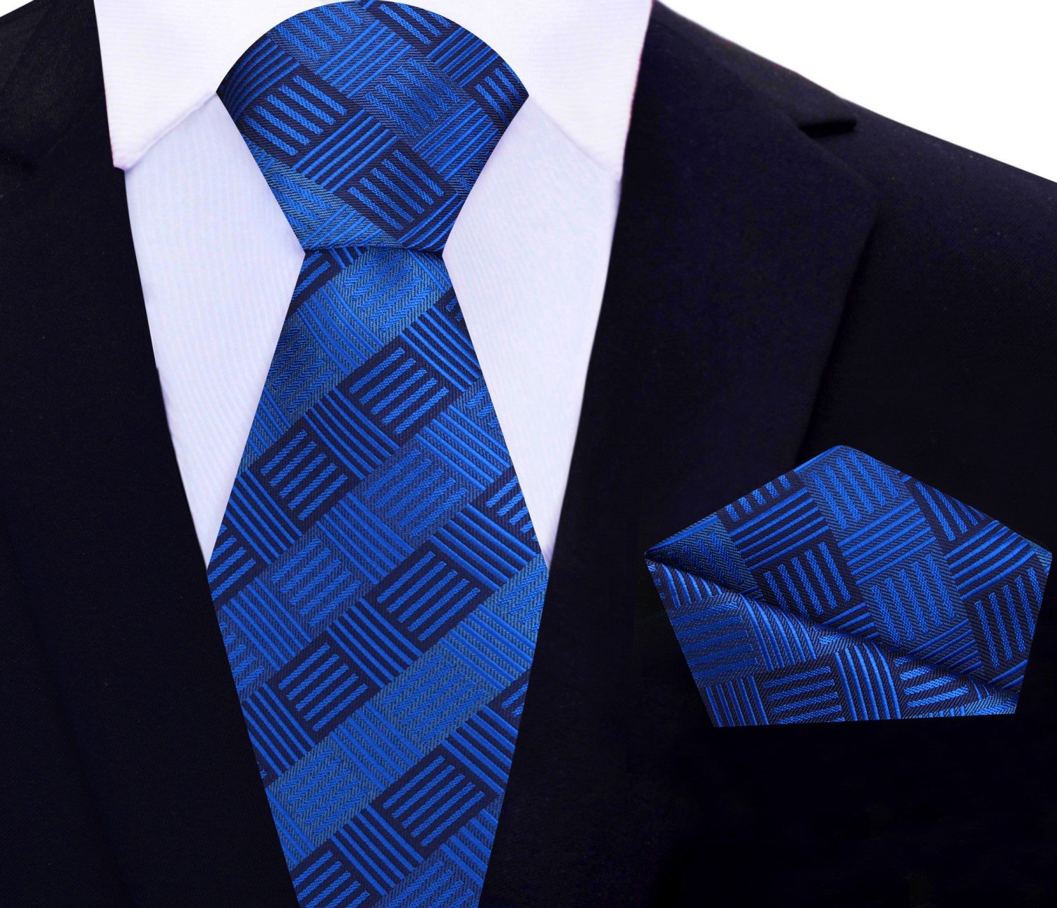 Front view of geometric silk necktie in deep blue, styled with white shirt and navy suit