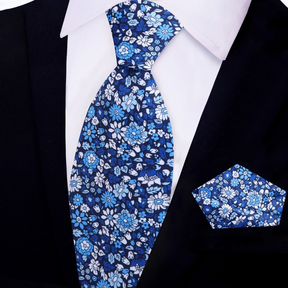 Matching pocket square for blue tie laid out on a suit jacket