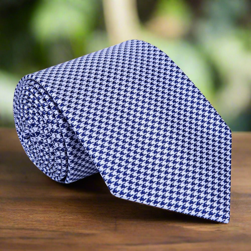 Close-up of metallic gold and black houndstooth silk necktie showcasing intricate pattern