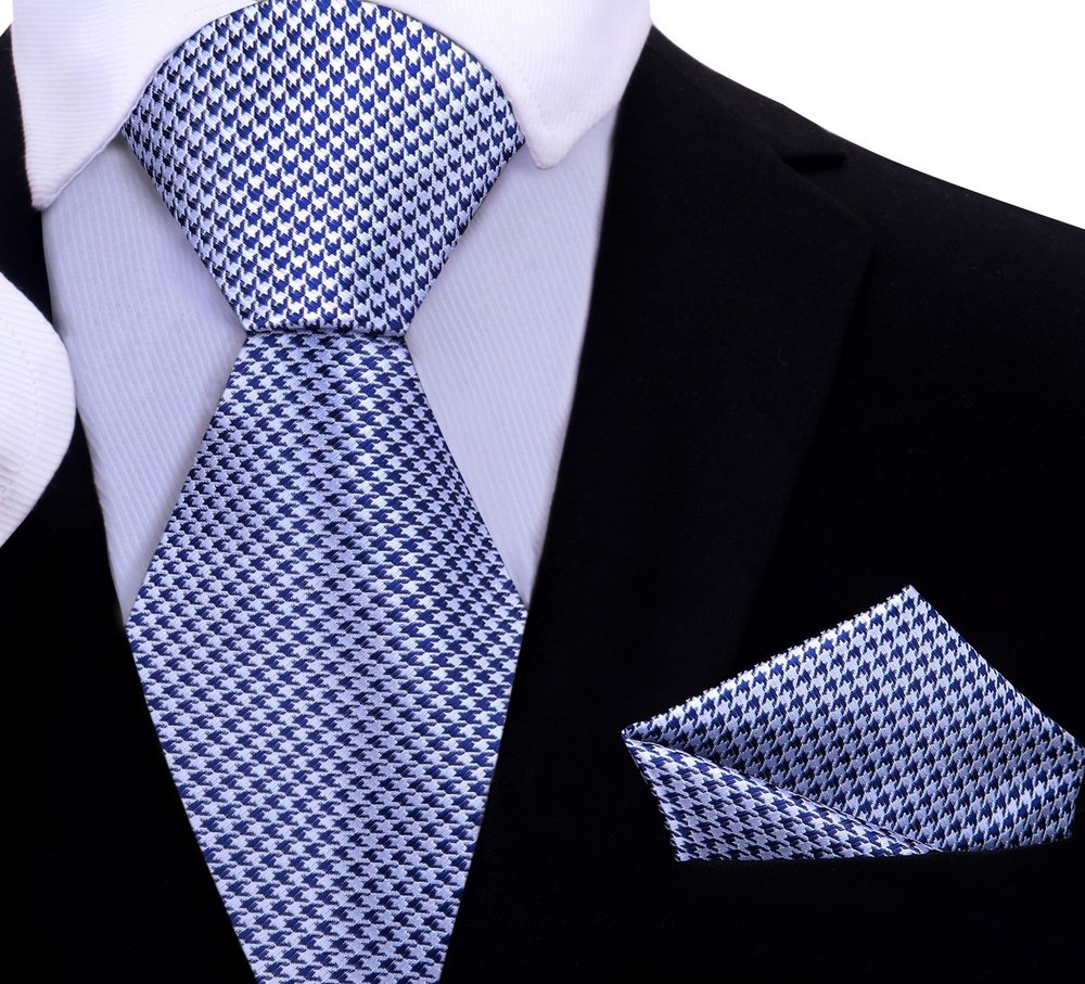 Matching pocket square in gold and black houndstooth design complementing the necktie