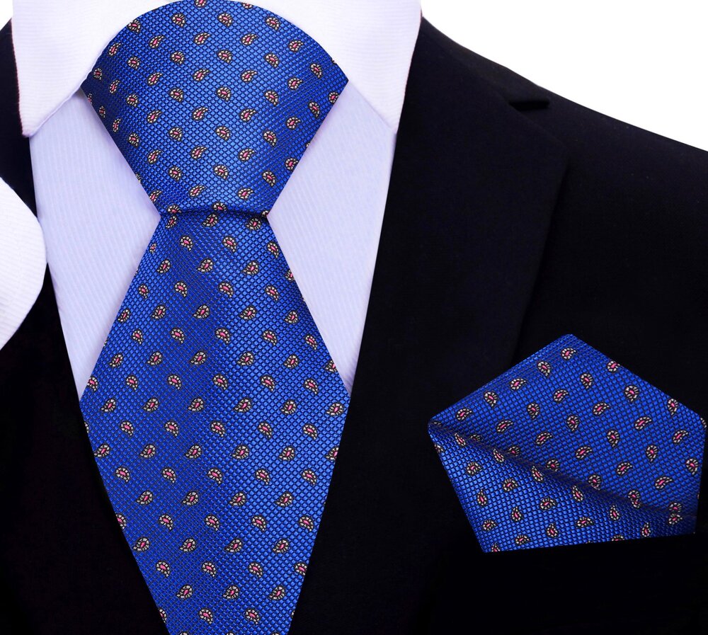Close-up of vibrant yellow paisley silk tie with intricate pattern