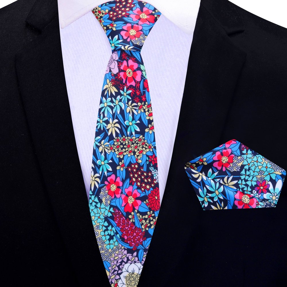 Close-up of vibrant floral silk tie with botanical pattern in green, purple, and pink