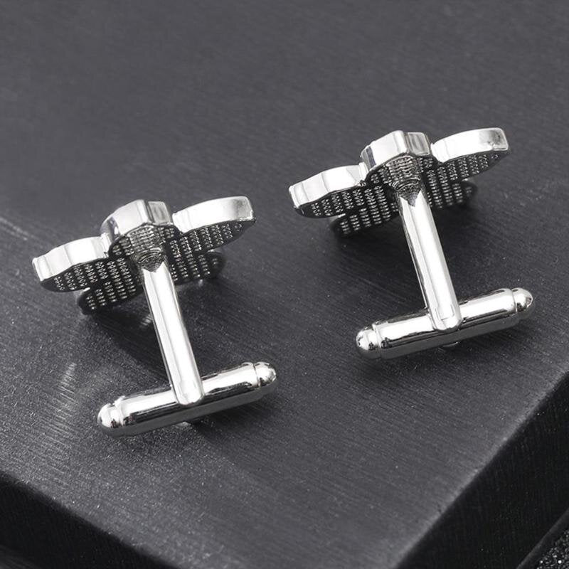 Cufflinks styled on navy blue suit sleeve for wedding accessories inspiration