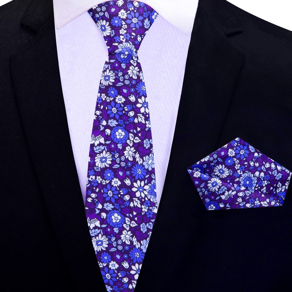 Elegant navy blue silk tie with floral pattern on a mannequin