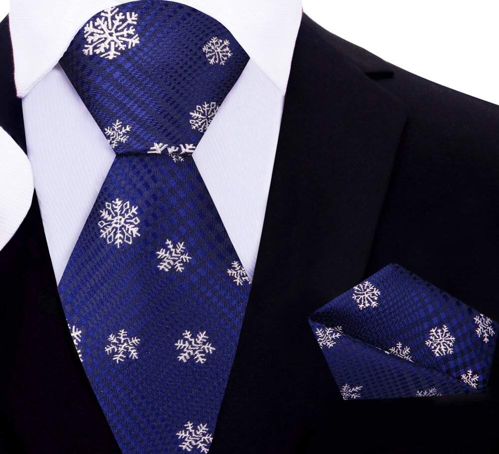 Close-up of the blue necktie showcasing the delicate falling snowflake pattern.