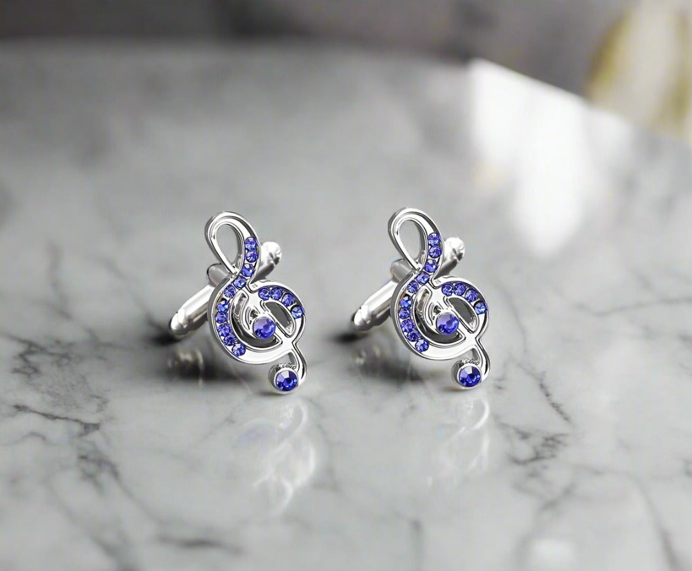 Close-up of blue music notes cufflinks with chrome finish on a white shirt