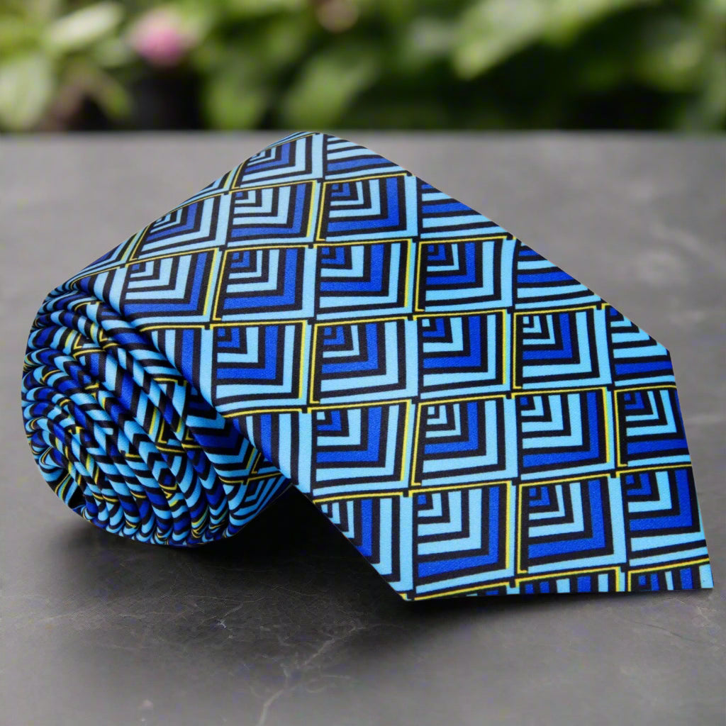 Nautilus geometric silk tie showcasing green and blue hues in a formal setting.