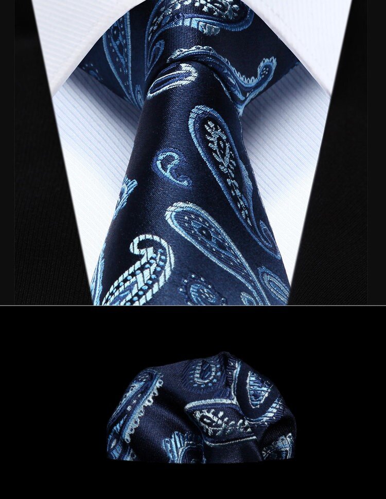 Blue paisley silk tie elegantly draped over a grey suit, perfect for business meetings.