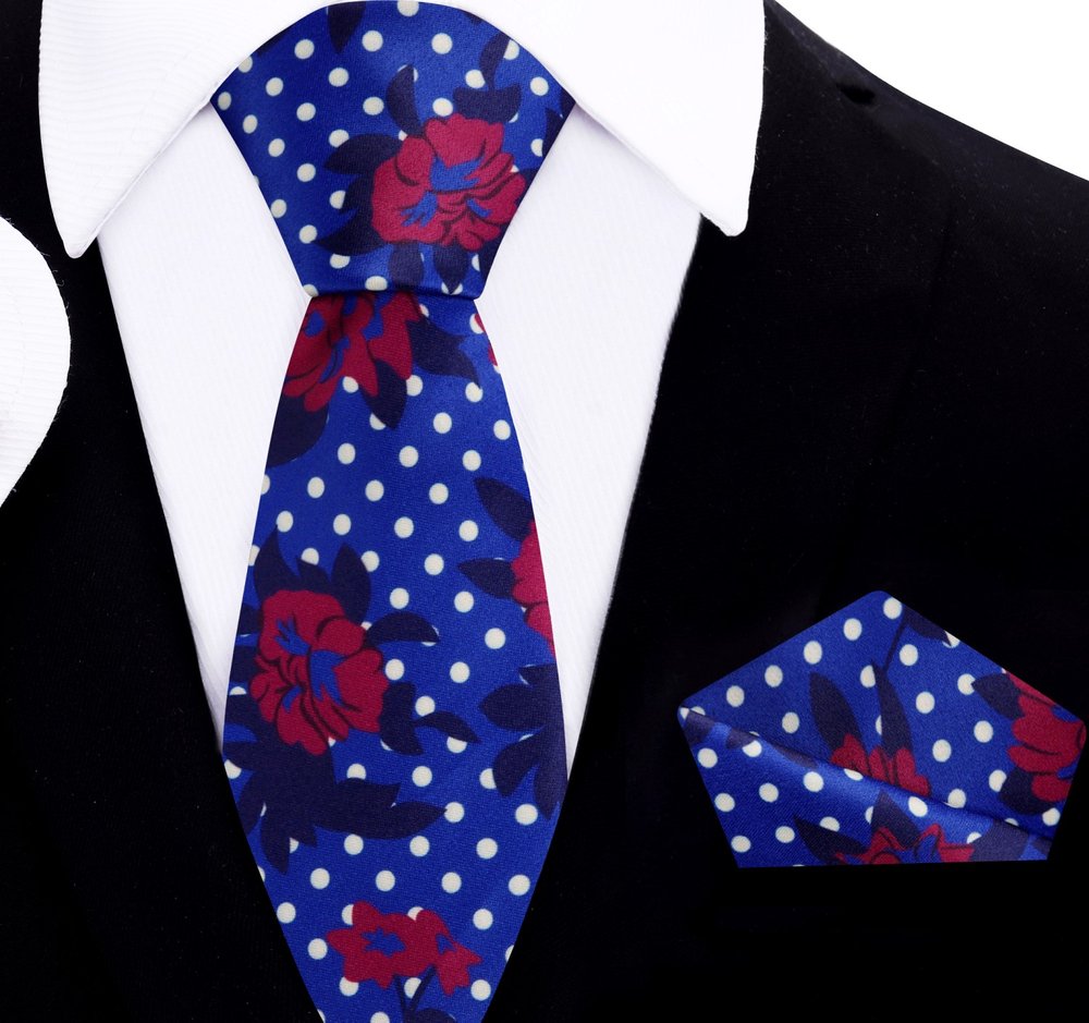 Tropical hibiscus silk tie on a wooden table, highlighting its vibrant colors and elegant design for summer weddings.