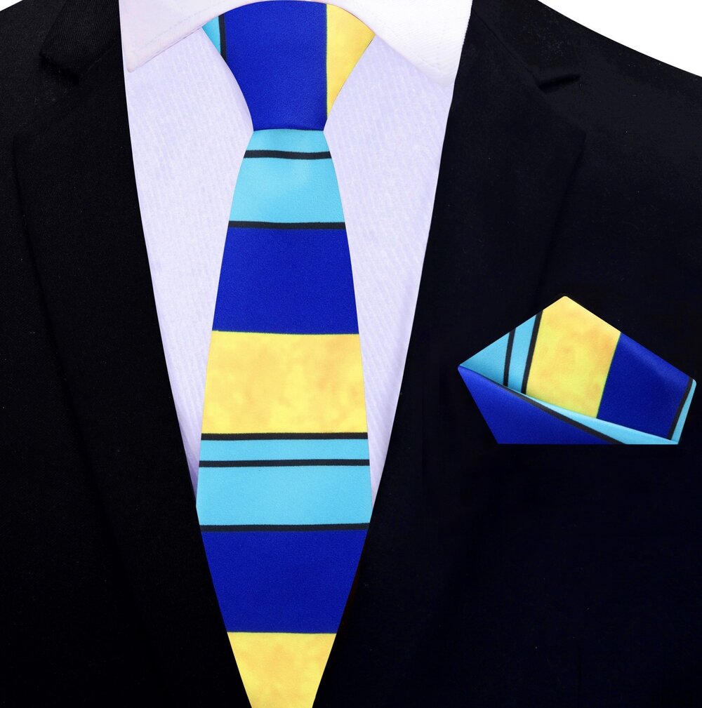 Model wearing the silk tie and pocket square set with a navy suit, demonstrating its versatility for formal events.