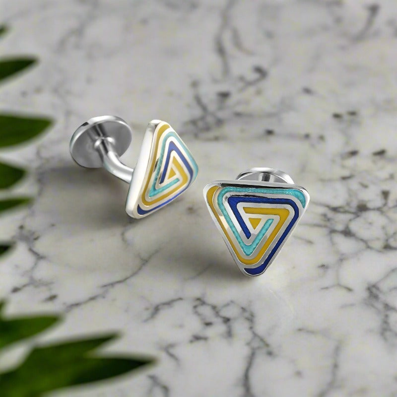 Close-up of PrismEdge chrome triangle cufflinks on a white dress shirt, highlighting the geometric design