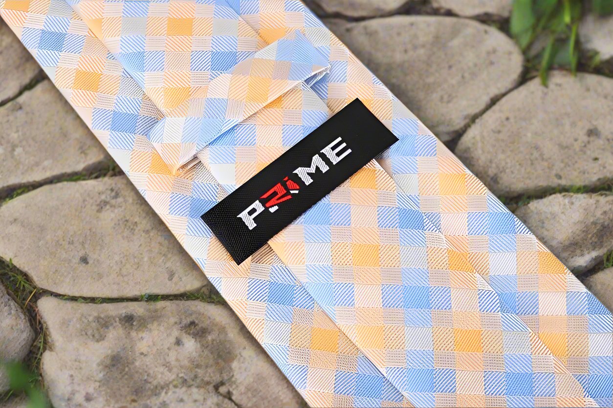 Close-up of vibrant modern plaid silk necktie in orange and light blue for mens fashion