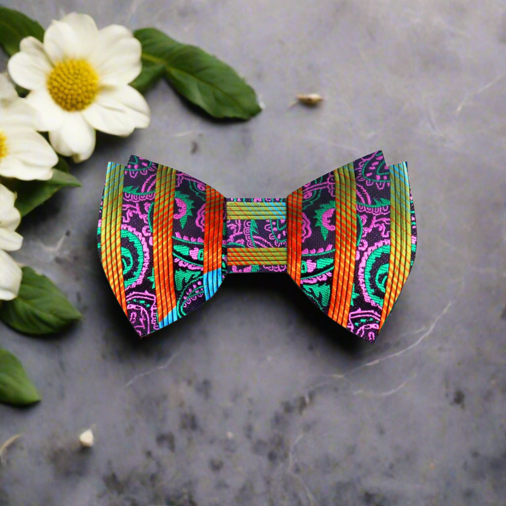 Close-up of vibrant paisley silk bow tie showcasing the intricate patterns and colors