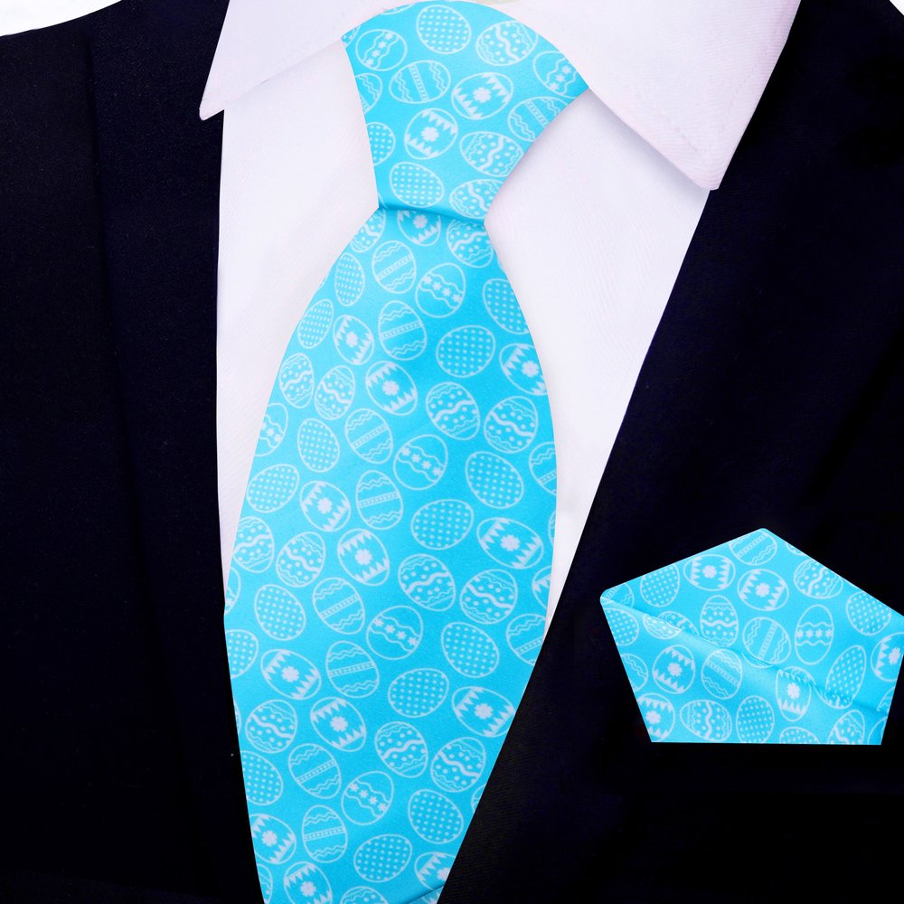 Close-up view of the light blue silk necktie with colorful Easter egg patterns.
