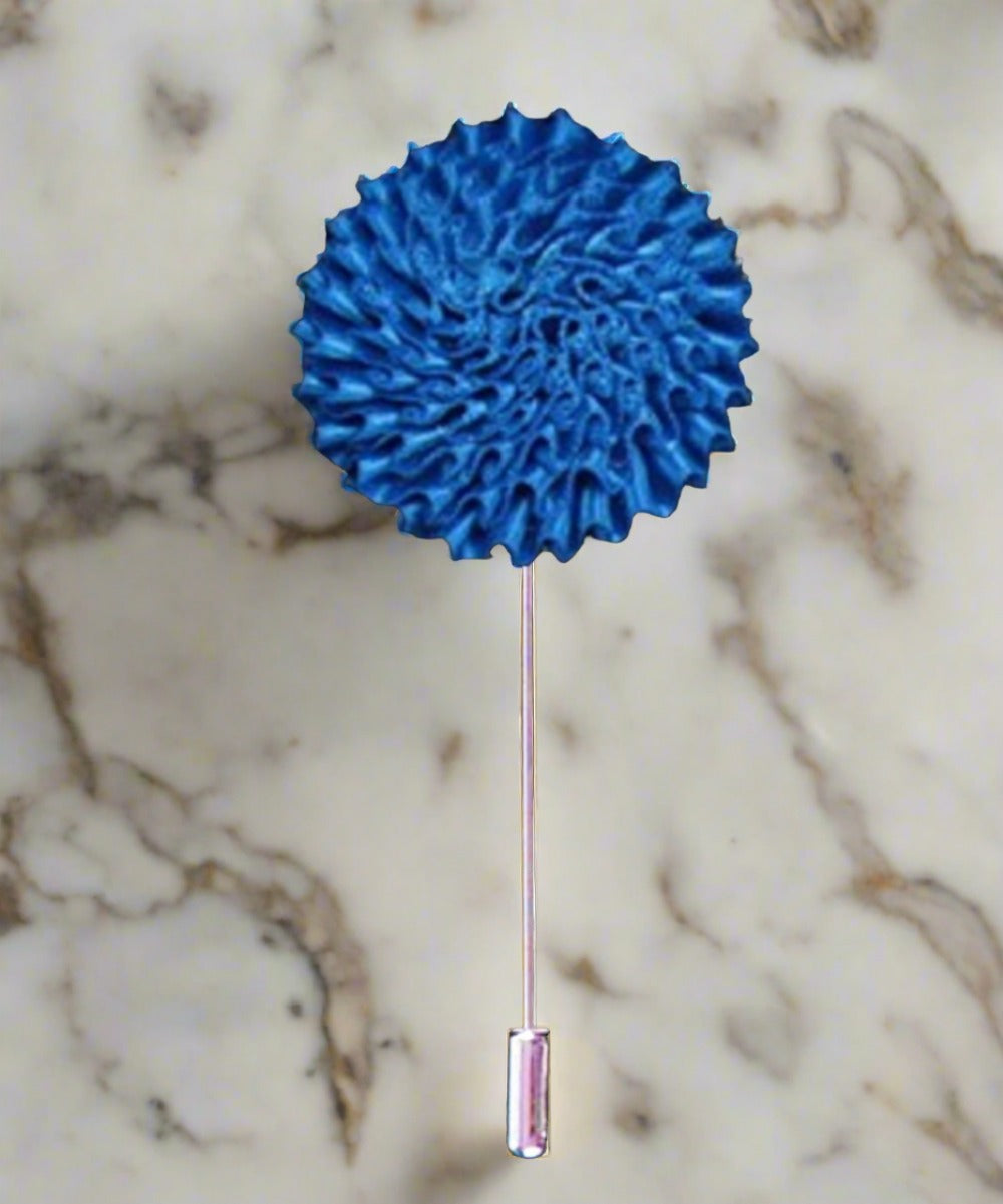 Vibrant burst fabric lapel pin with colorful floral design on a blazer