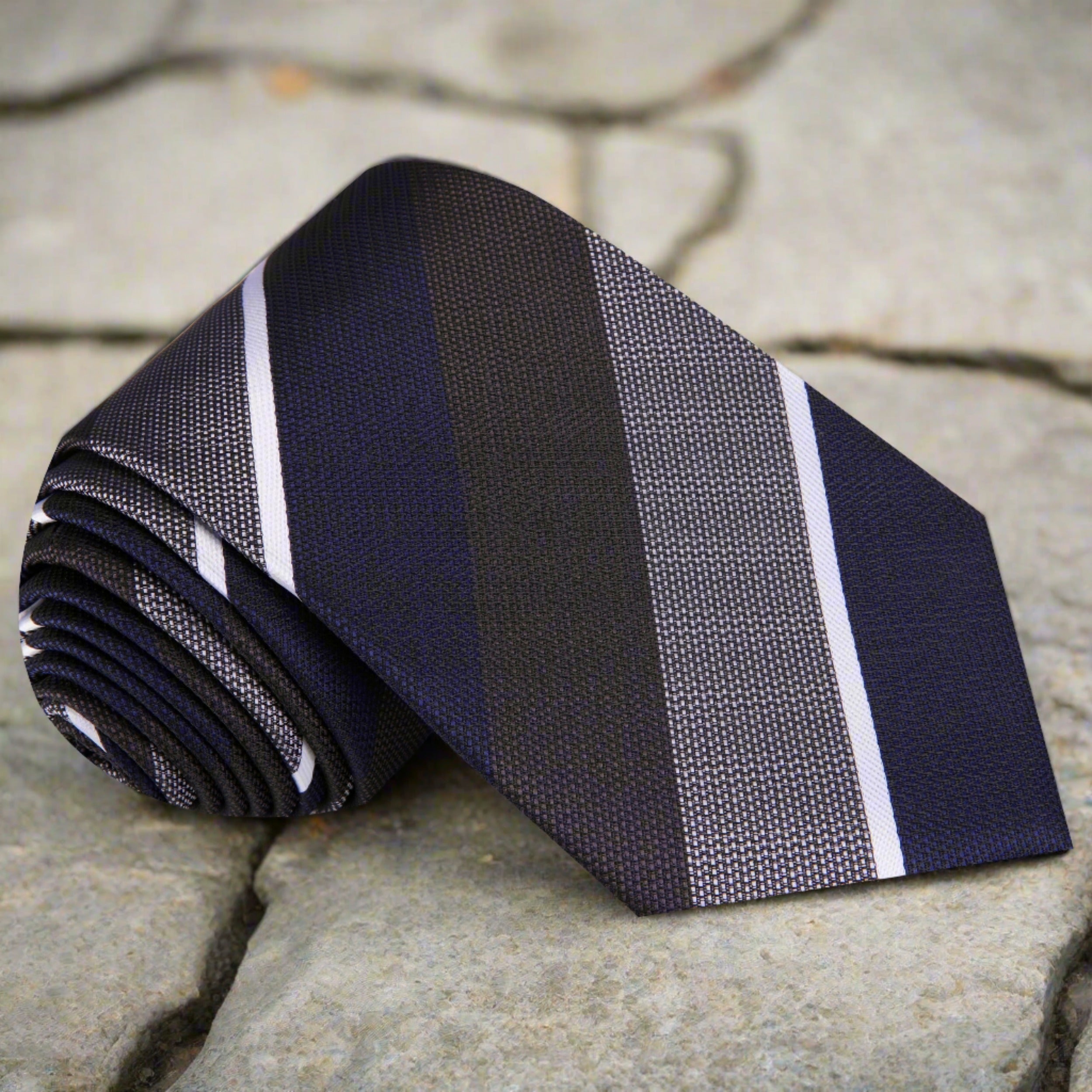 Close-up of silk tie showing navy, olive, and grey striped pattern—ideal for formal ties for business meetings.