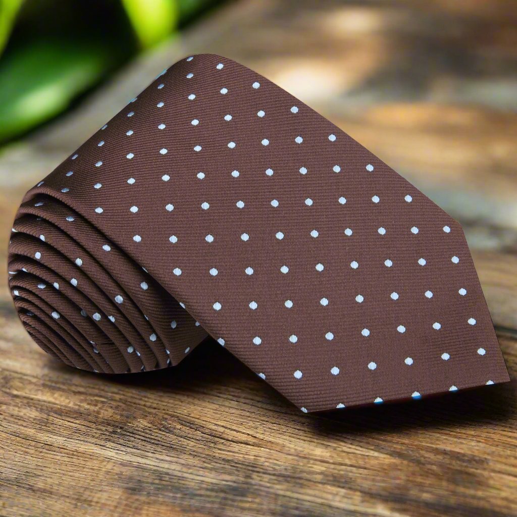 Close-up of brown silk tie with light blue polka dots, ideal for formal dinners