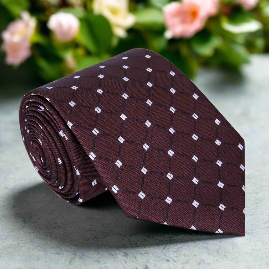 Brown geometric necktie displayed on a white background, showcasing its intricate design.