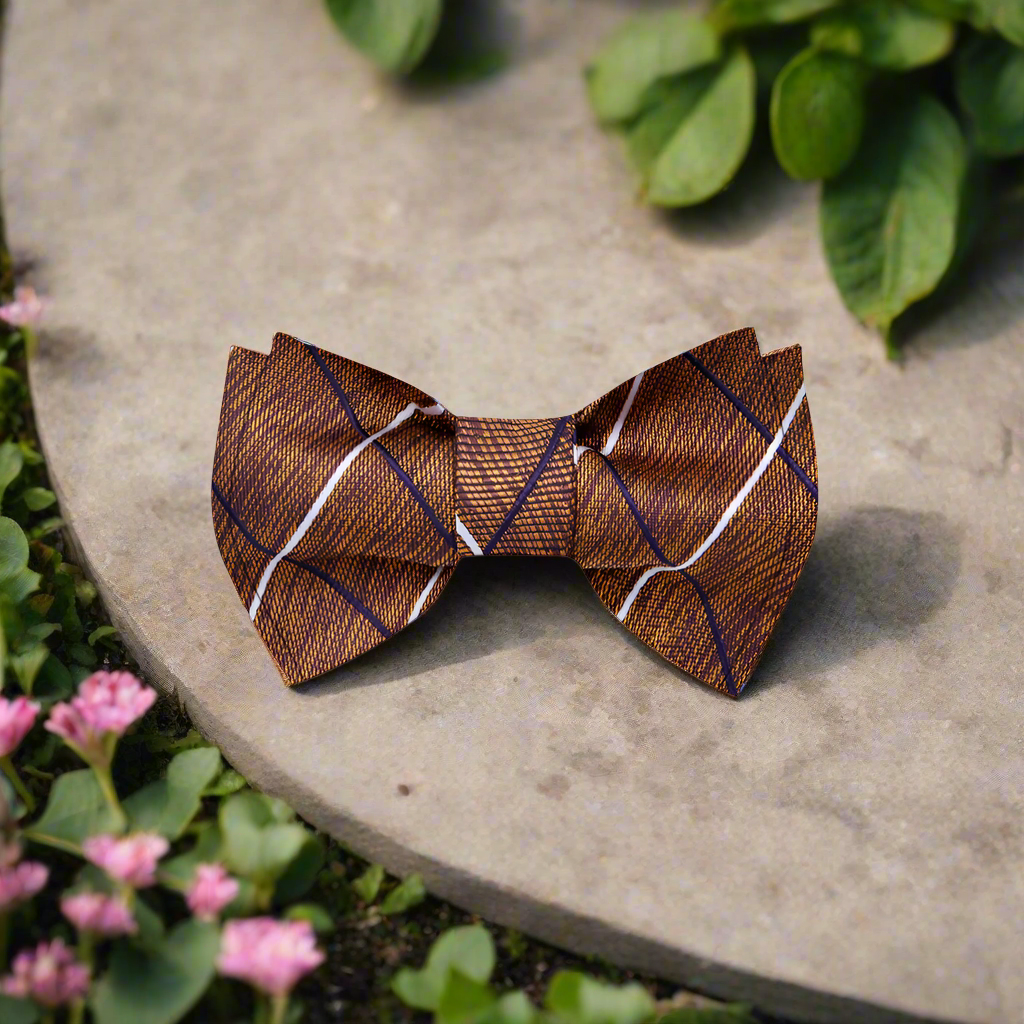 Man wearing plaid silk bow tie with pocket square at outdoor autumn wedding