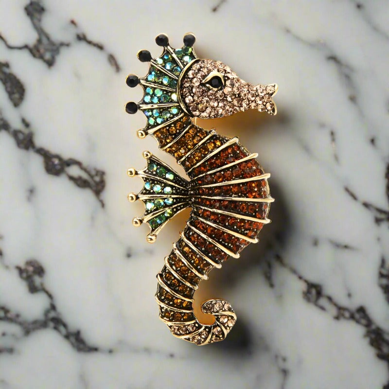 Colorful exotic animal pins with gemstones displayed for gift ideas