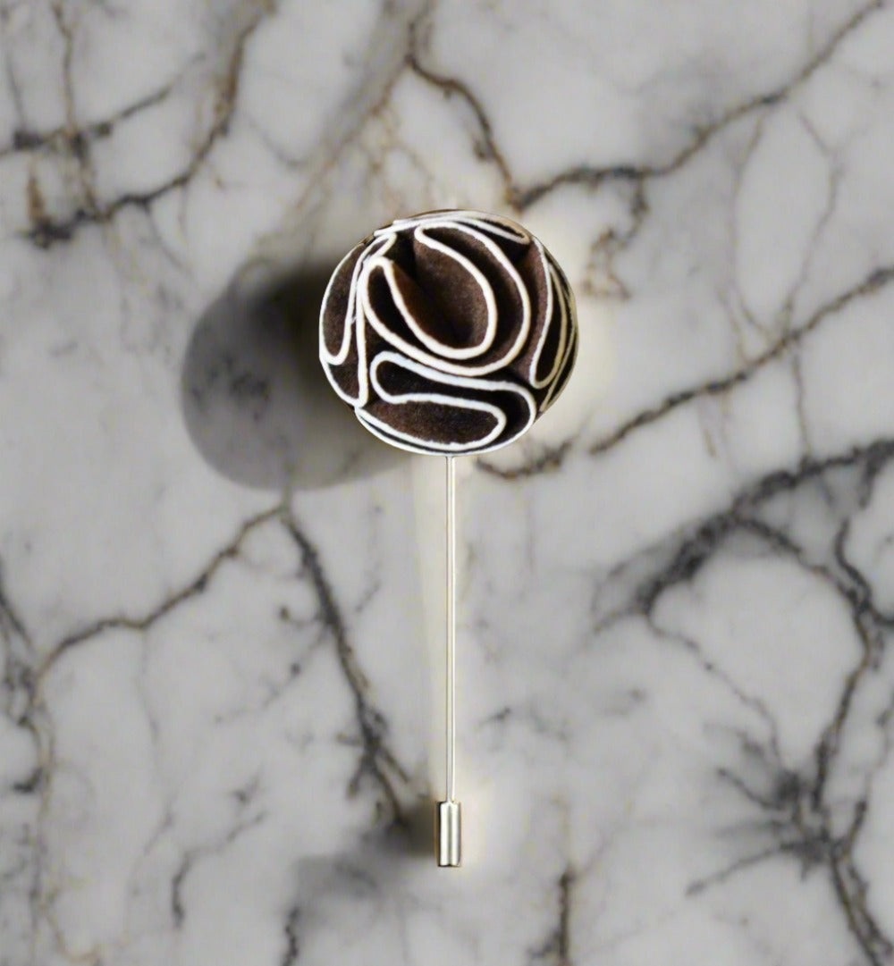 Close-up of the elegant custom flower lapel pin in burgundy and yellow.