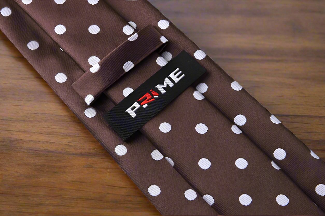 Elegant brown polka dot necktie on a formal dress shirt.