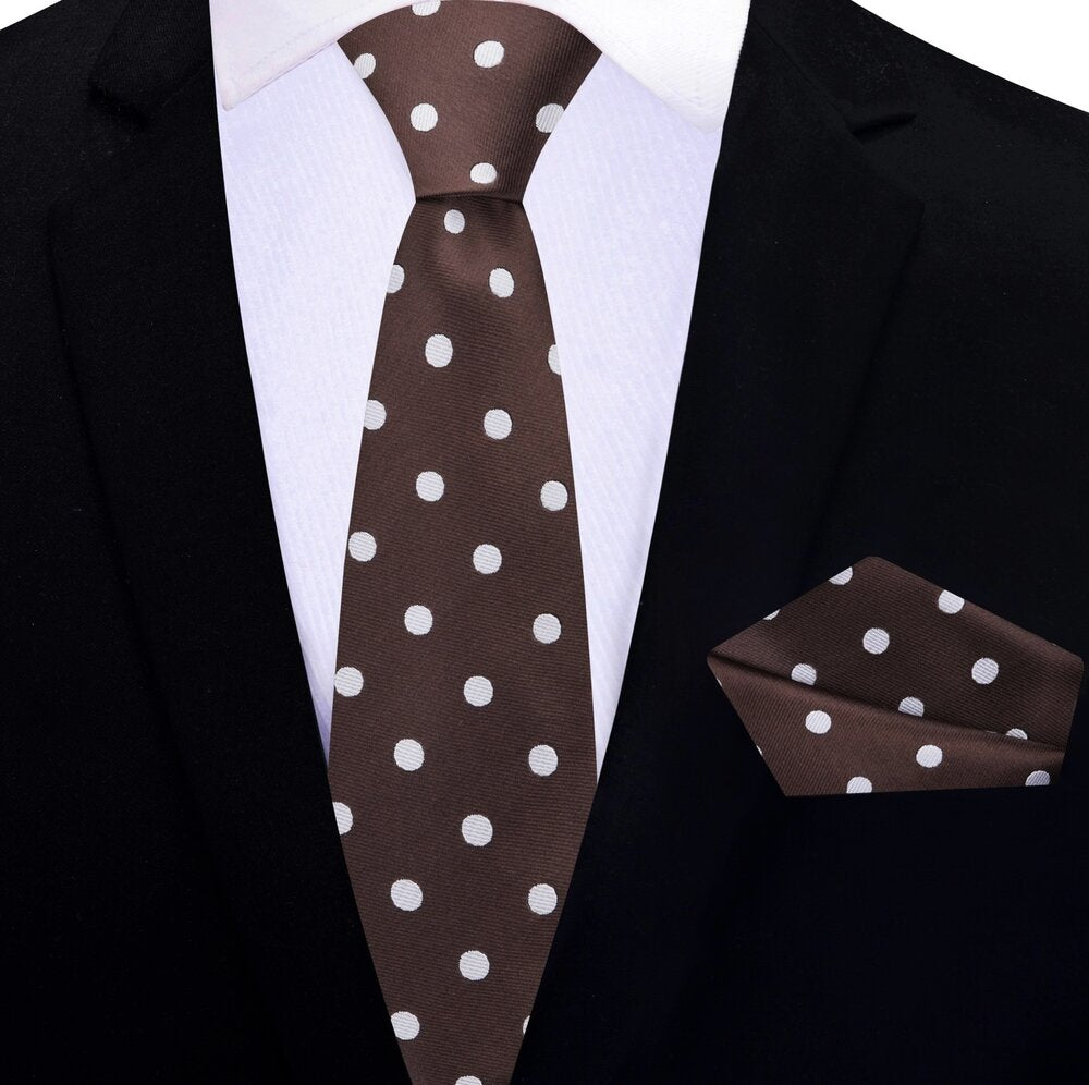 Brown polka dot necktie styled with a navy suit for a wedding.