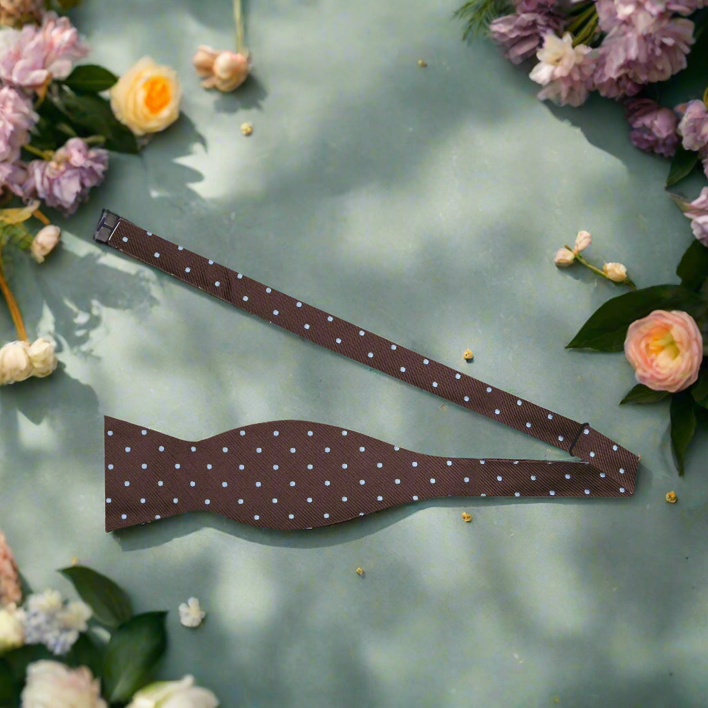 Close-up of brown silk polka dot bow tie showing detailed pattern