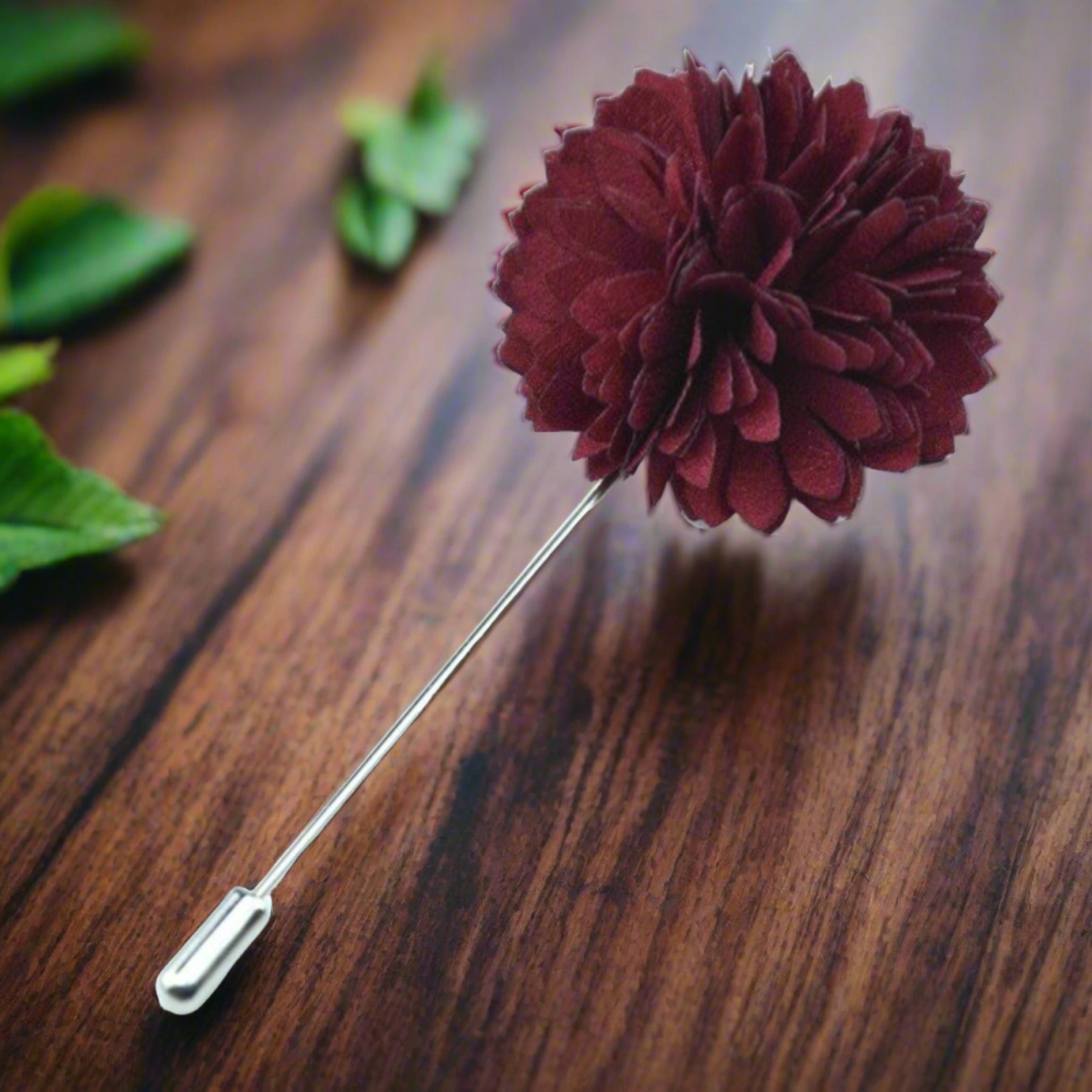 Elegant fabric lapel pin in deep blue, perfect for formal wear.