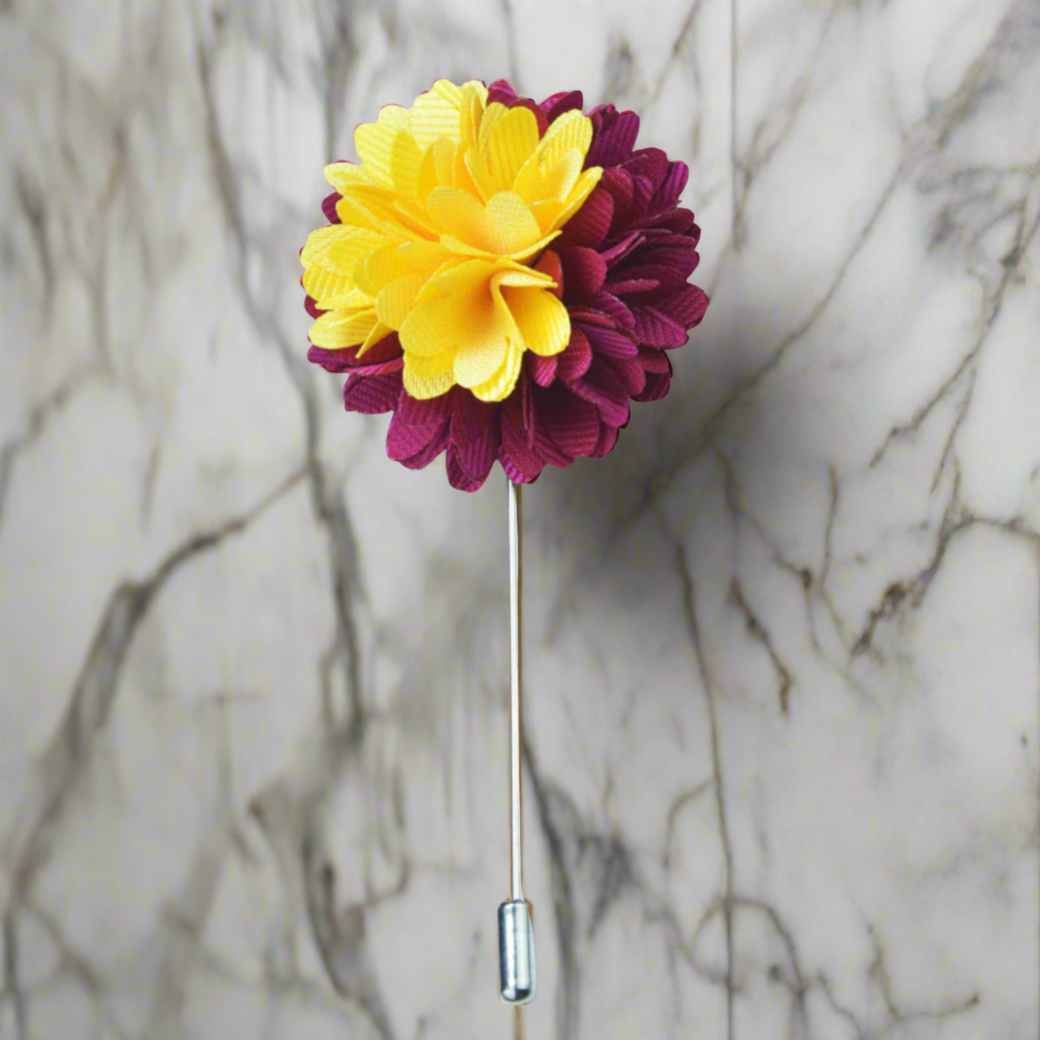 Top view of the Regal Blossom lapel pin showcasing burgundy petals with golden accents