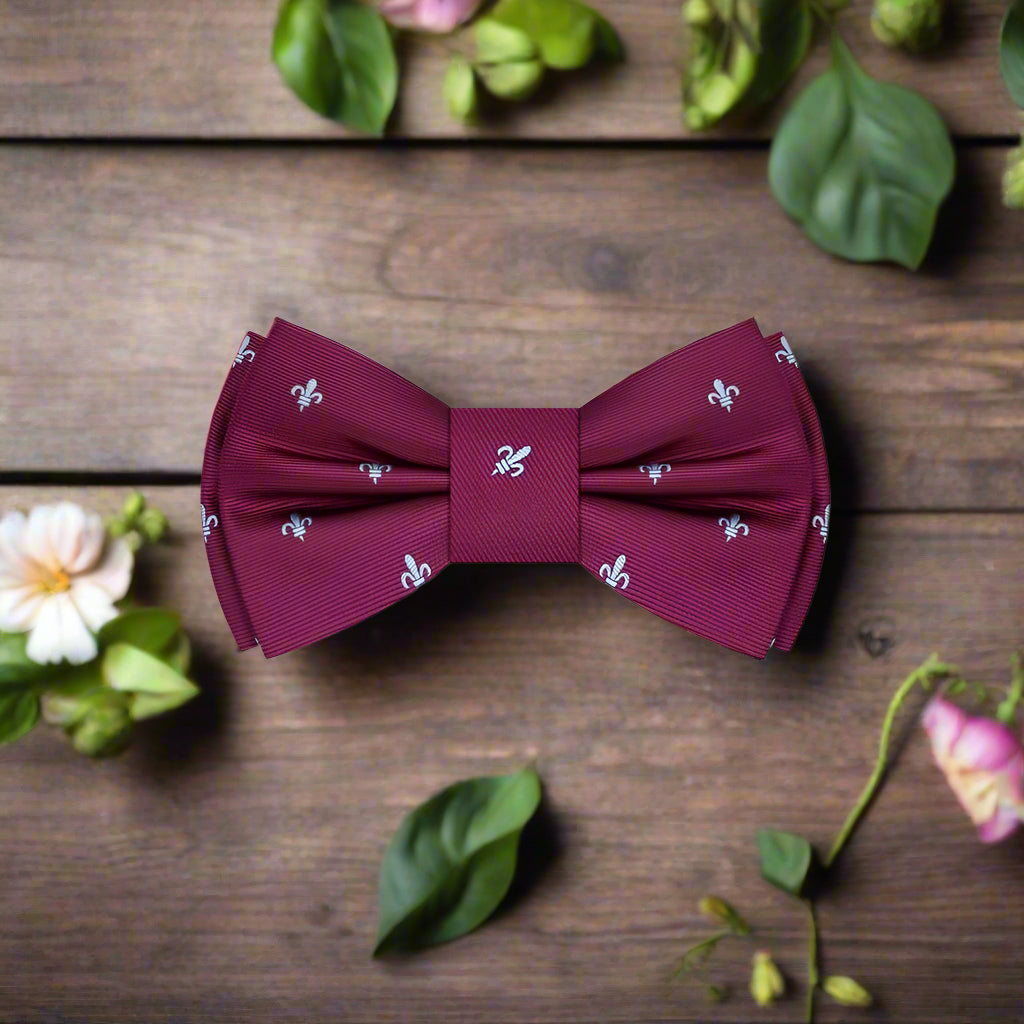 Deep red fleur de lis silk bow tie worn with a tuxedo for formal events