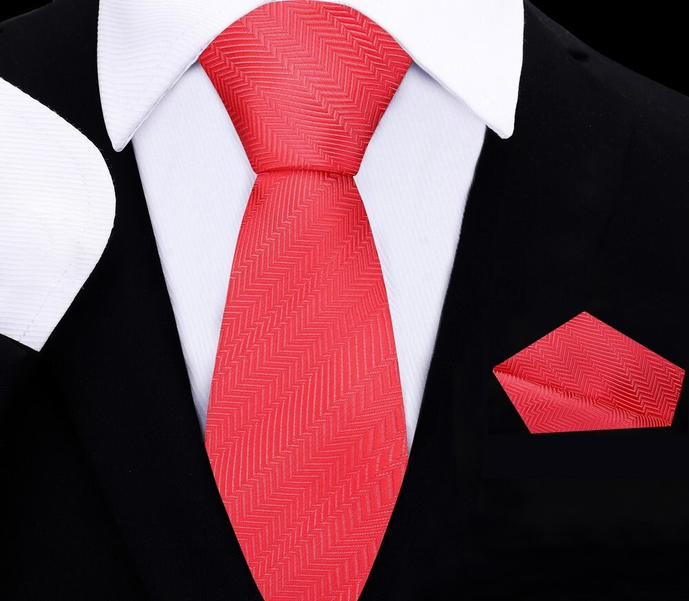 Close-up of vibrant coral kids necktie and silk pocket square set for boys' formal wear