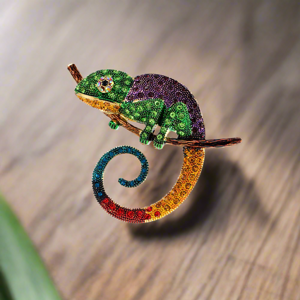 Vibrant chameleon lapel pin showcasing colorful gemstones from a side view.