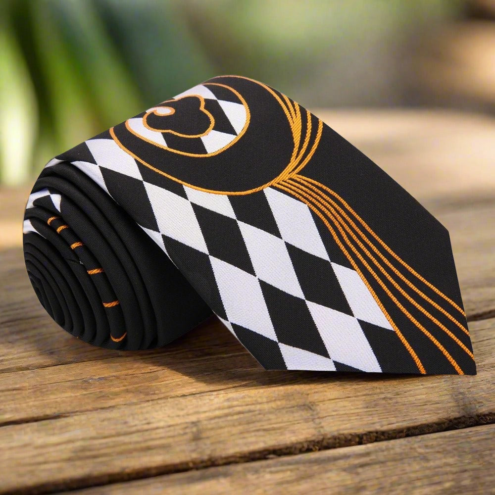 Close-up of black and white checkered silk necktie with gold paisley pattern