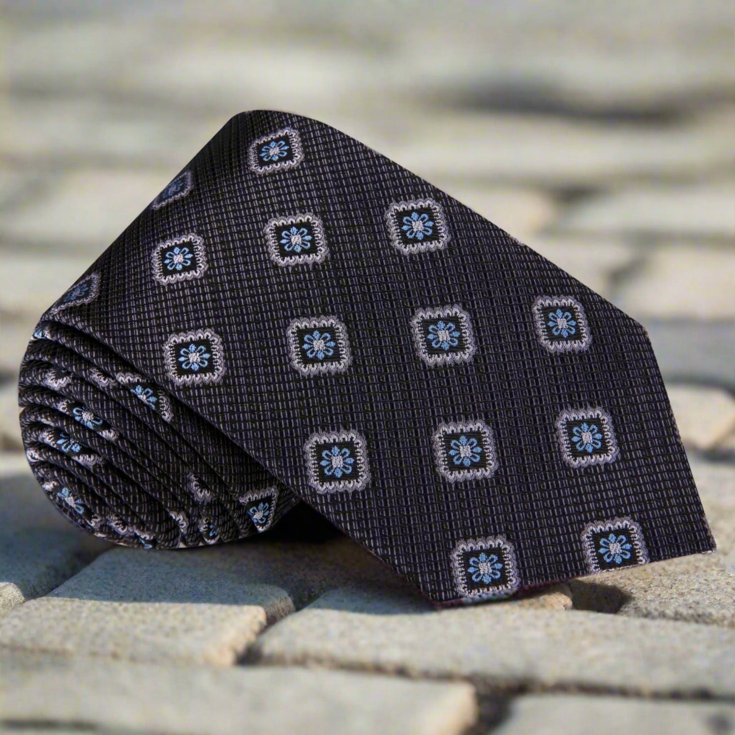 Geometric Elegance Silk Tie displayed against a white background, showcasing its intricate pattern and luxurious fabric.