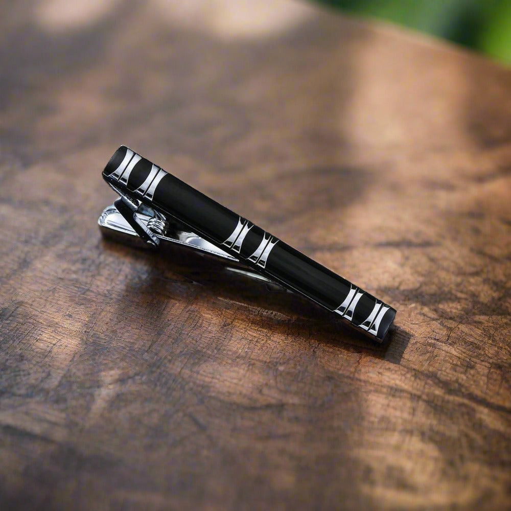 Gold checkerboard tie bar, adding a touch of modern elegance to mens dress accessories.